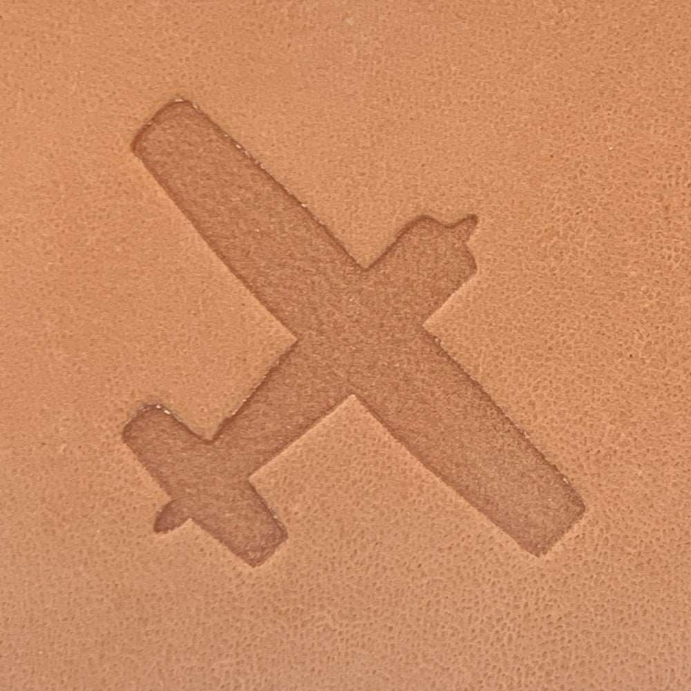 Clean airplane silhouette stamped into vegetable-tanned leather using a Delrin leather stamp.
