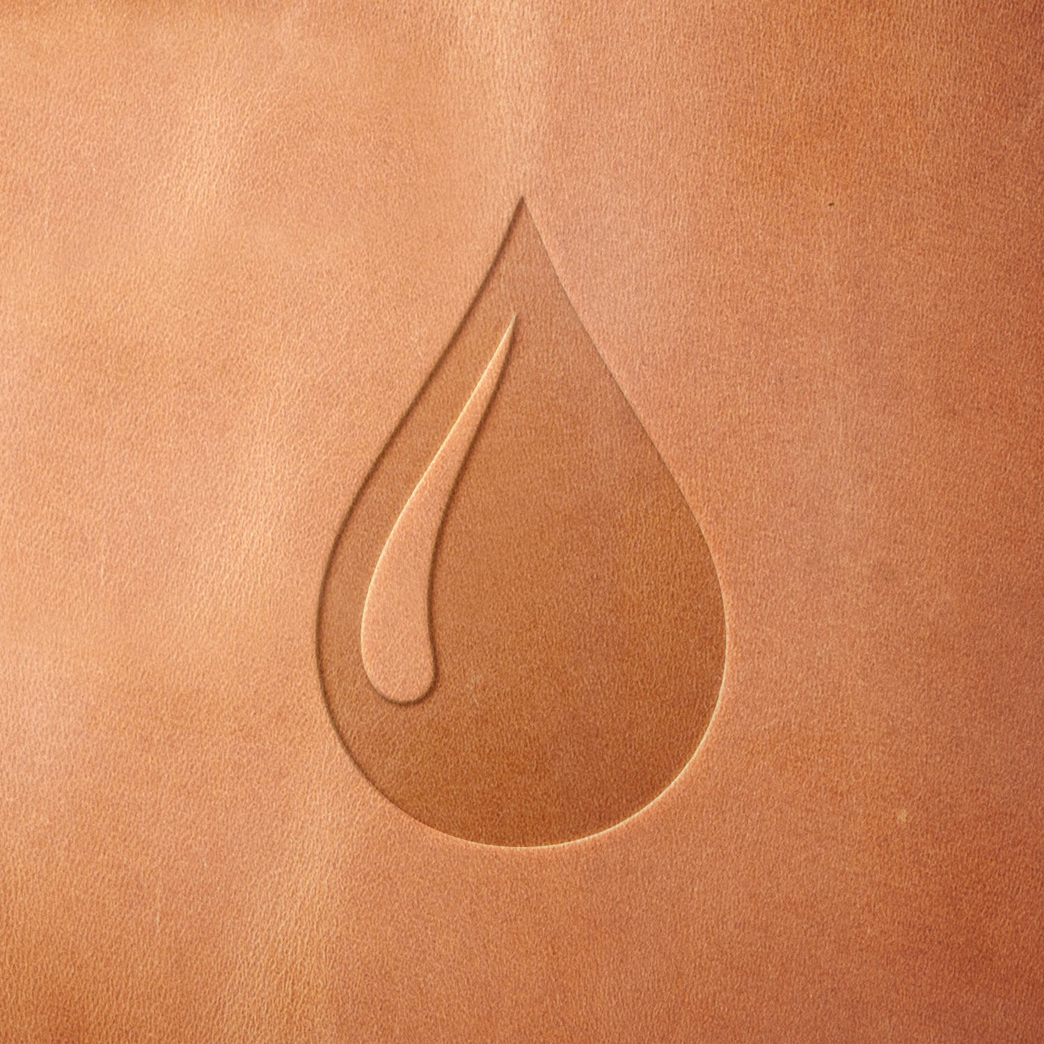 Leather sample with a crisp water drop stamp impression from a Delrin leather stamp, ideal for creating high-quality water-themed leathercraft projects.