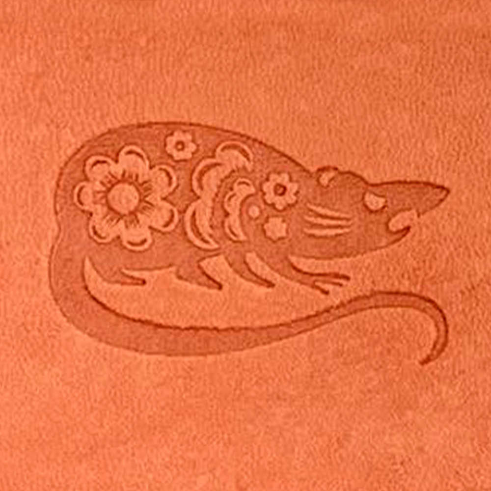 The Chinese Zodiac Rat Delrin Leather Stamp showcases an orange surface embossed with a stylized rat adorned with intricate floral patterns. The rat is illustrated with a long tail, pointed snout, and round ears.